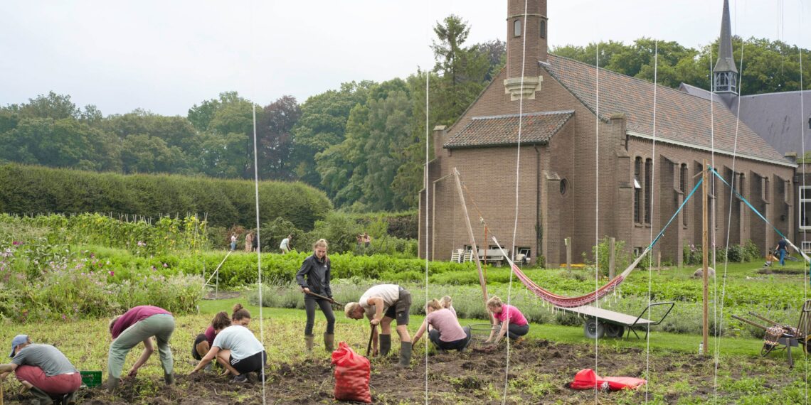 Woongemeenschap van Klooster Nieuw Sion. Mensen zijn aan het werk in de tuin