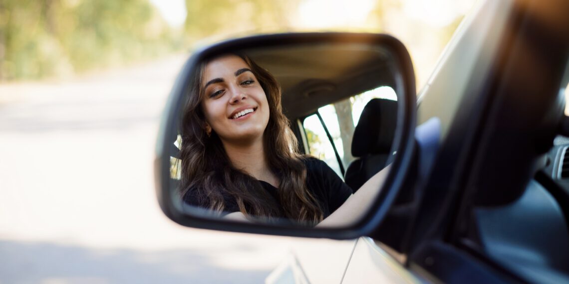 Meisje in autospiegel