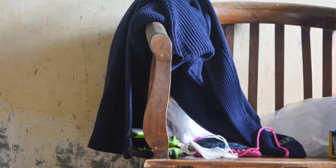 Kleding en anders spullen op een houten stoel gelegd