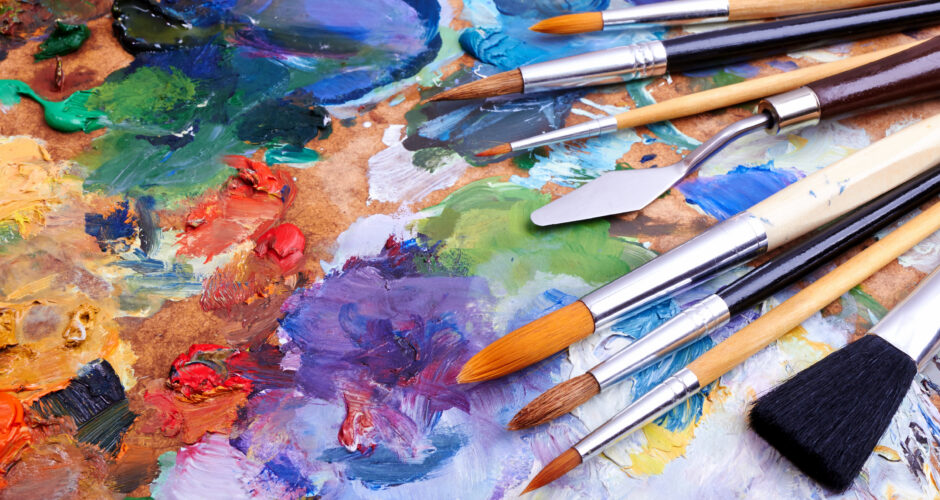 artists brushes and oilpaints on wooden palette