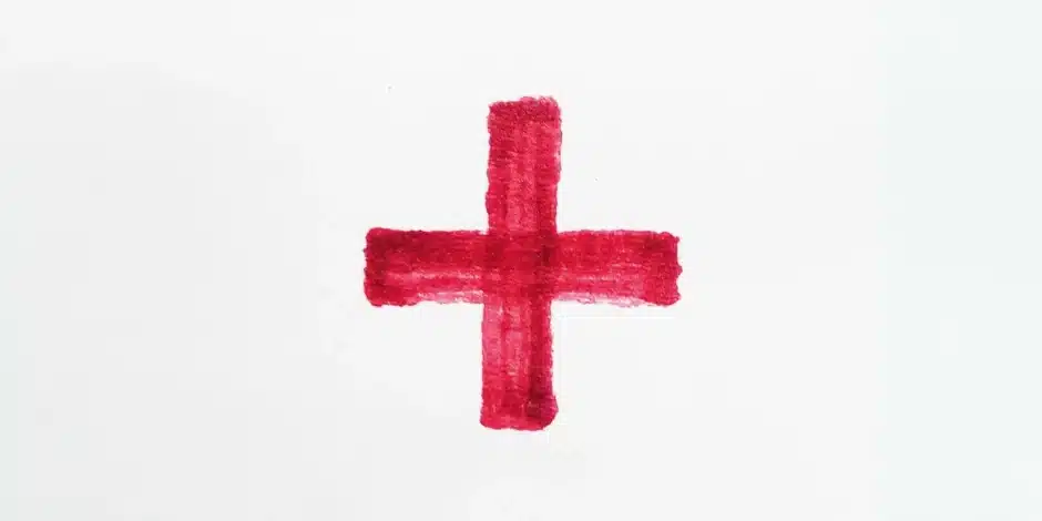 een geverfd rood kruis op een witte achtergrond